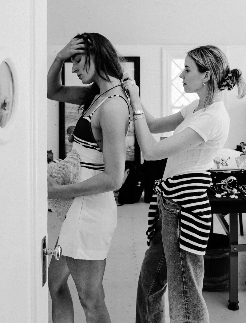 Annie fitting a client, in black and white