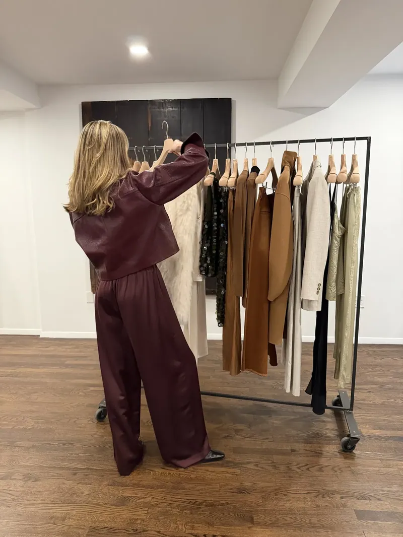 Annie pulling pieces from a clothing rack